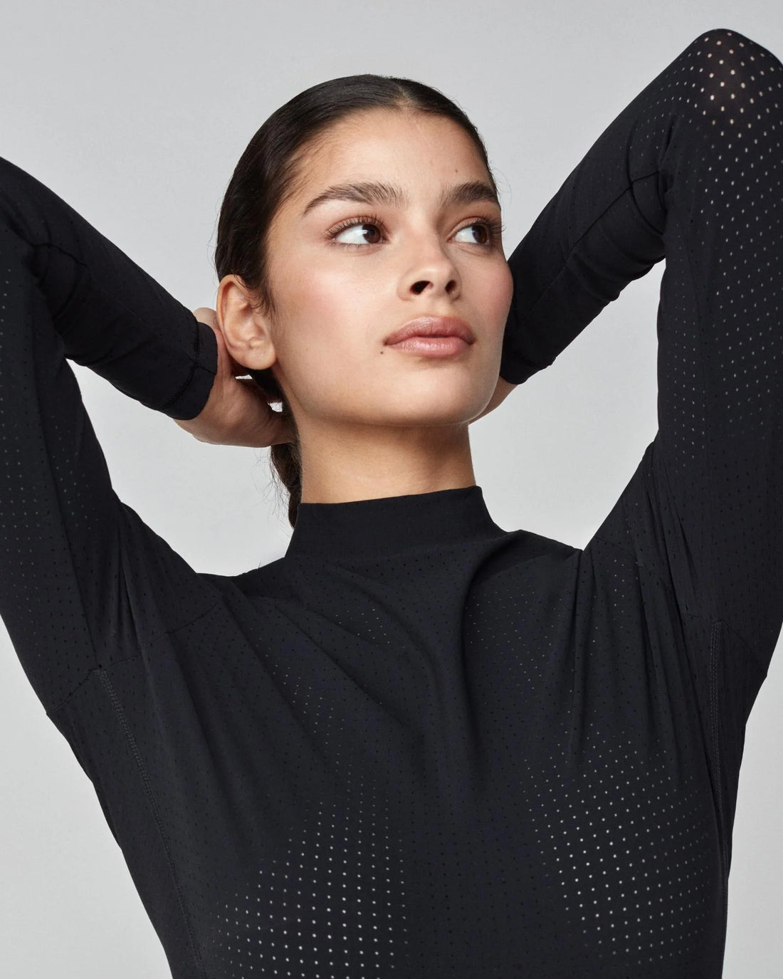 Black | AirTech Long Sleeve, on model with arms raised showing the mesh panels