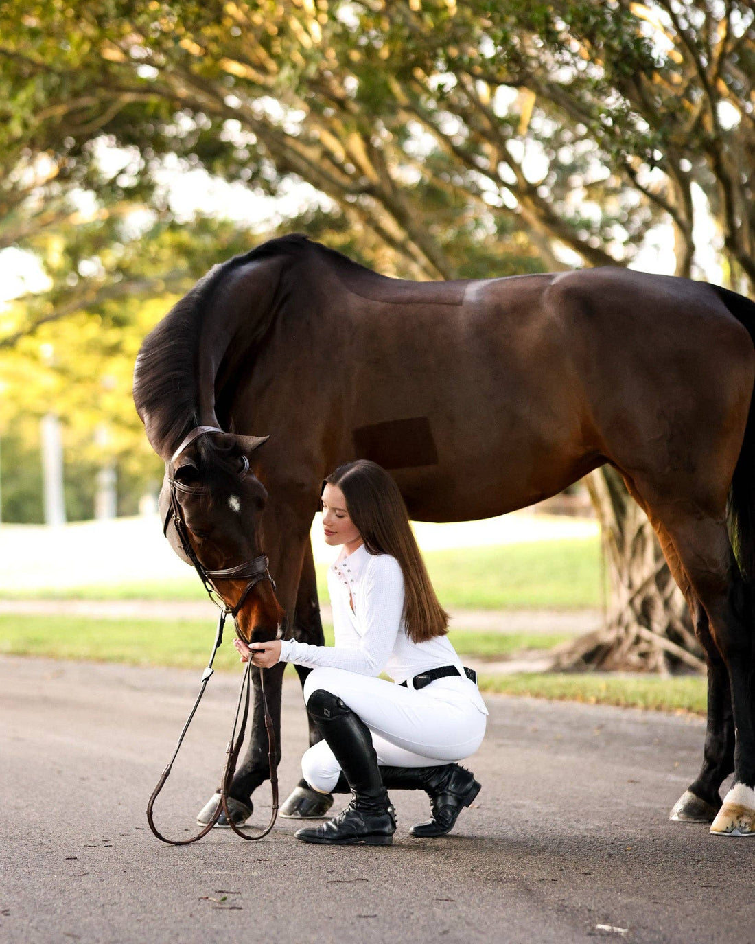 White | Lia Show Shirt, on model crouching beside a horse