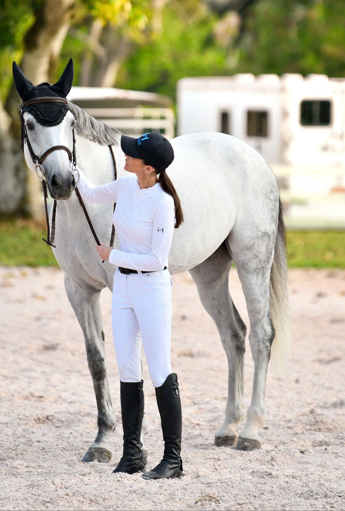 White | Elevated Standard Performance™ Micro Mesh Top, micro mesh top on model standing with a grey horse